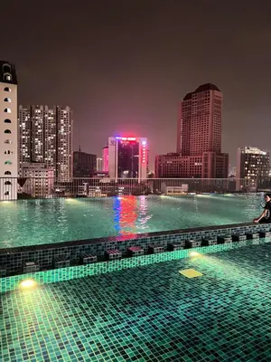 a swimming pool with a city skyline at night at Chambers Residence by Golden Homestay in Kuala Lumpur