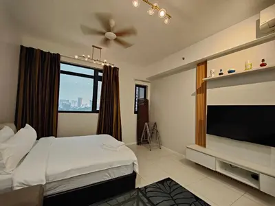 a hotel room with a bed and a flat screen tv at Chambers Residence by Golden Homestay in Kuala Lumpur