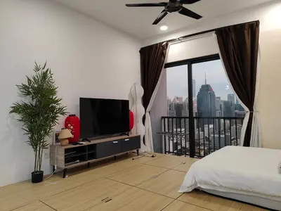 a bedroom with a bed and a flat screen tv at Chambers Residence by Golden Homestay in Kuala Lumpur