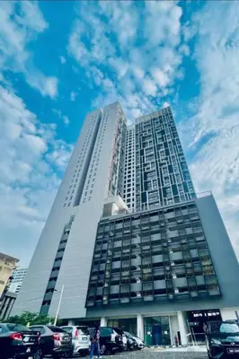a tall building with cars parked in front of it at Chambers Residence by Golden Homestay in Kuala Lumpur