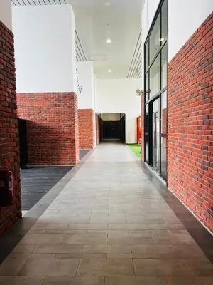 an empty corridor of a building with red brick walls at Chambers Residence by Fancy House in Kuala Lumpur