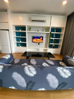 a living room with a bed in front of a tv at The Platinum Suites KLCC in Kuala Lumpur
