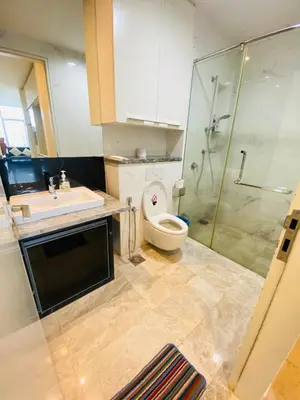a bathroom with a toilet and a sink and a shower at The Platinum Suites KLCC in Kuala Lumpur