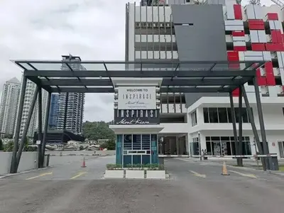 a large building with a sign in front of it at Inspirasi Mont Kiara Cozy Homestay with Pool View Kuala Lumpur in Kuala Lumpur