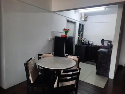 a table and chairs in a room with a kitchen at Homestay Lala in Kuala Lumpur