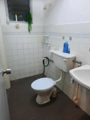 a bathroom with a toilet and a sink at Homestay Lala in Kuala Lumpur