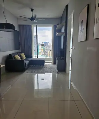 a living room with a couch and a large window at The Signature Suites at Robertson Bukit Bintang in Kuala Lumpur