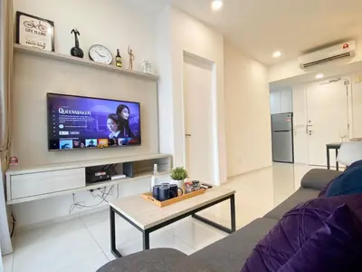 a living room with a flat screen tv on a wall at The Loft Living Suites at Robertson Residences in Kuala Lumpur