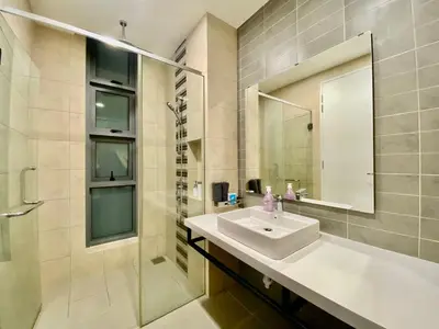a bathroom with a sink and a shower and a mirror at The Loft Living Suites at Robertson Residences in Kuala Lumpur