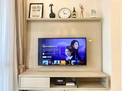 a flat screen tv sitting on top of a shelf at The Loft Living Suites at Robertson Residences in Kuala Lumpur