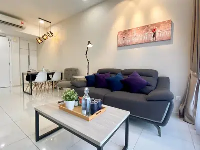 a living room with a couch and a table at The Loft Living Suites at Robertson Residences in Kuala Lumpur
