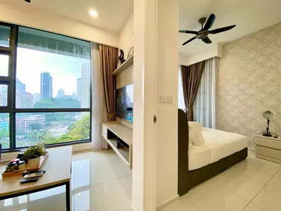 a living room with a bed and a large window at The Loft Living Suites at Robertson Residences in Kuala Lumpur