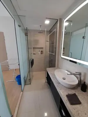 a bathroom with a white sink and a shower at Star Residences One in Kuala Lumpur