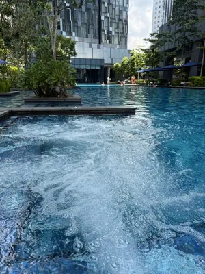 a swimming pool with blue water in a city at Star Residences One in Kuala Lumpur