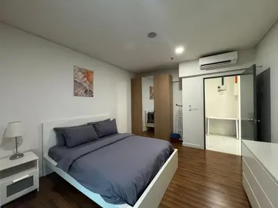a bedroom with a bed and a sliding glass door at Summer Suites KLCC Apartments by Soulasia in Kuala Lumpur