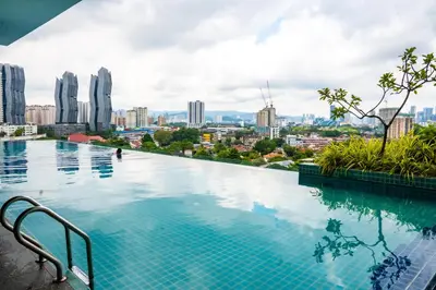 a swimming pool with a city skyline in the background at Entire Apartment in Kuala Lumpur, Infinity Pool!! in Kuala Lumpur