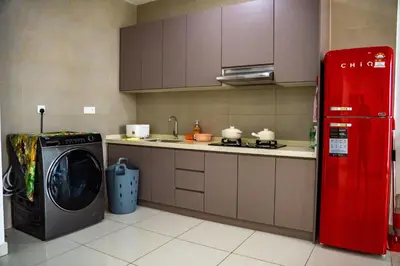 a kitchen with a washing machine and a red refrigerator at Entire Apartment in Kuala Lumpur, Infinity Pool!! in Kuala Lumpur