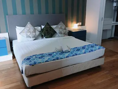 a bedroom with a large bed with a blue and white comforter at KLCC Sky villa Suites Platinum by MiM in Kuala Lumpur