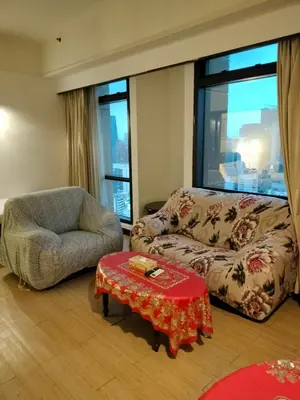 a living room with a couch and a chair at Global suites at time square KL in Kuala Lumpur