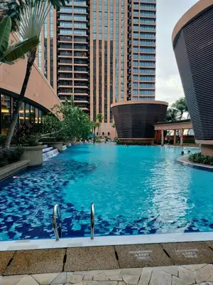 two dolphins swimming in a large pool in a city at Global suites at time square KL in Kuala Lumpur