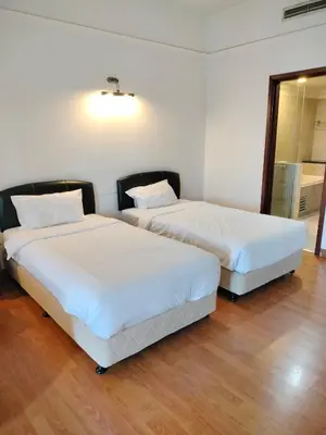 two beds sitting next to each other in a room at Global suites at time square KL in Kuala Lumpur