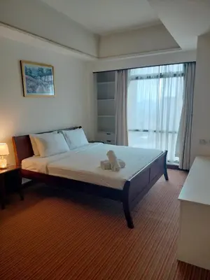 a bedroom with a bed with a teddy bear on it at Global suites at time square KL in Kuala Lumpur