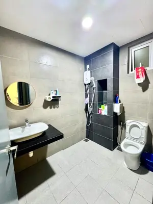 a bathroom with a toilet and a sink and a mirror at 3Room 5 Pax stay in Mont Kiara in Kuala Lumpur
