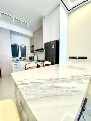 a kitchen with a large marble counter top at 3Room 5 Pax stay in Mont Kiara in Kuala Lumpur