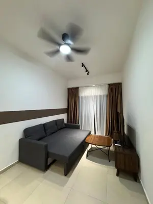 a living room with a couch and a ceiling fan at 10 Pax stay in Kl Area in Kuala Lumpur