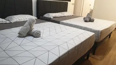 two beds with stuffed animals on them in a bedroom at 10 Pax stay in Kl Area in Kuala Lumpur