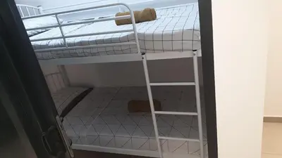 a bunk bed with a ladder next to a room at 10 Pax stay in Kl Area in Kuala Lumpur