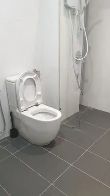a bathroom with a toilet with the seat up at 10 Pax stay in Kl Area in Kuala Lumpur