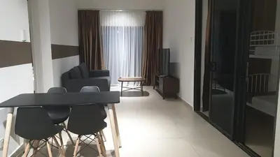 a living room with a black table and chairs at 10 Pax stay in Kl Area in Kuala Lumpur