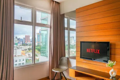 a living room with a tv and a large window at Dua Sentral Kuala Lumpur near KL Sentral in Kuala Lumpur