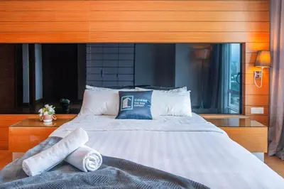 a bedroom with a large bed with towels on it at Dua Sentral Kuala Lumpur near KL Sentral in Kuala Lumpur