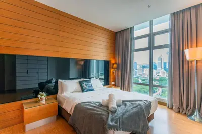 a bedroom with a bed and a large window at Dua Sentral Kuala Lumpur near KL Sentral in Kuala Lumpur