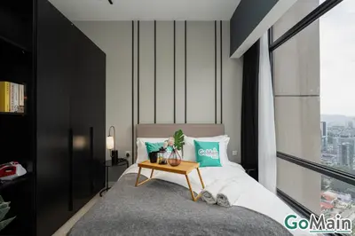 a bedroom with a bed with a table in it at AXON BUKIT BINTANG w Skypool - Walk to Pavilion KLCC KL TRX in Kuala Lumpur