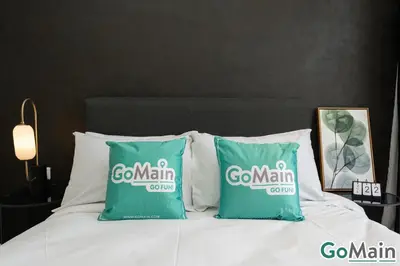 a couple of green pillows on a bed at AXON BUKIT BINTANG w Skypool - Walk to Pavilion KLCC KL TRX in Kuala Lumpur