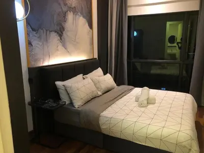 a bedroom with a bed with two white pillows at Cozy Stay in KLCC\u5409\u9686\u73bb in Kuala Lumpur