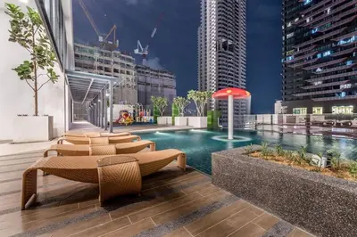 a swimming pool in a city with tall buildings at Cozy Stay in KLCC\u5409\u9686\u73bb in Kuala Lumpur