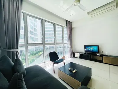 a living room with a couch and a large window at Regalia Residences And Suites By The Relaxstay in Kuala Lumpur
