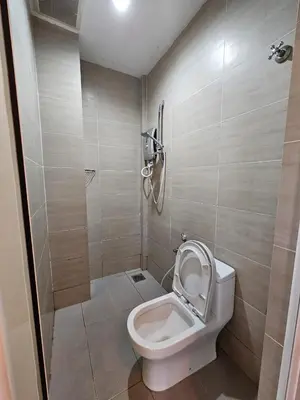 a small bathroom with a toilet and a shower at V Garden Hotel by Minsu in Kuala Lumpur