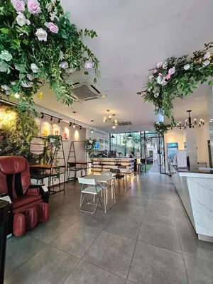 a restaurant with tables and chairs and flowers hanging from the ceiling at V Garden Hotel by Minsu in Kuala Lumpur