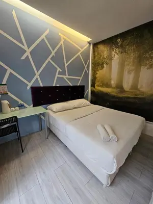 a bedroom with a bed with two white towels on it at V Garden Hotel by Minsu in Kuala Lumpur