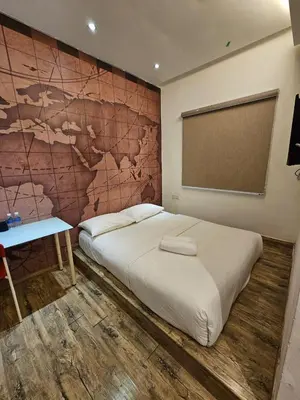 a bed in a room with a map on the wall at V Garden Hotel by Minsu in Kuala Lumpur