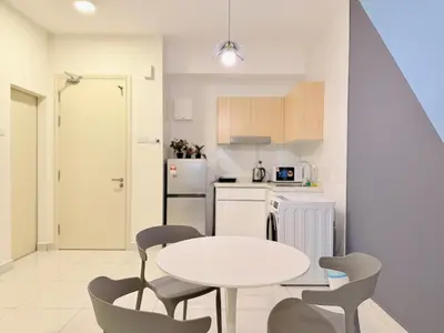 a kitchen with a table and chairs in a room at Arte Mont Kiara By The Relaxstay in Kuala Lumpur