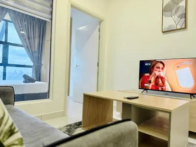 a living room with a table with a tv on it at Arte Mont Kiara By The Relaxstay in Kuala Lumpur
