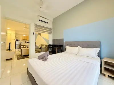 a bedroom with a large white bed with a stuffed animal on it at Arte Mont Kiara By The Relaxstay in Kuala Lumpur