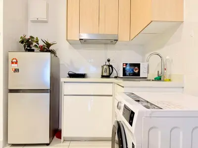 a white kitchen with a refrigerator and a microwave at Arte Mont Kiara By The Relaxstay in Kuala Lumpur