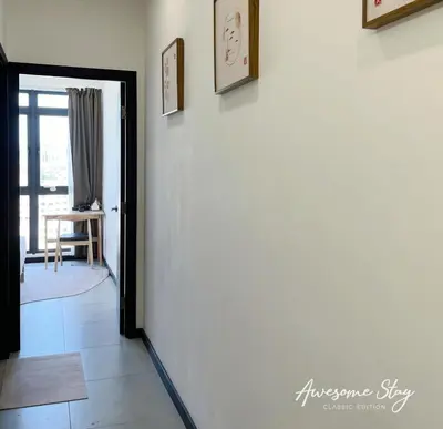 a hallway with a door leading into a room at Neu Suites By The Relaxstay in Kuala Lumpur